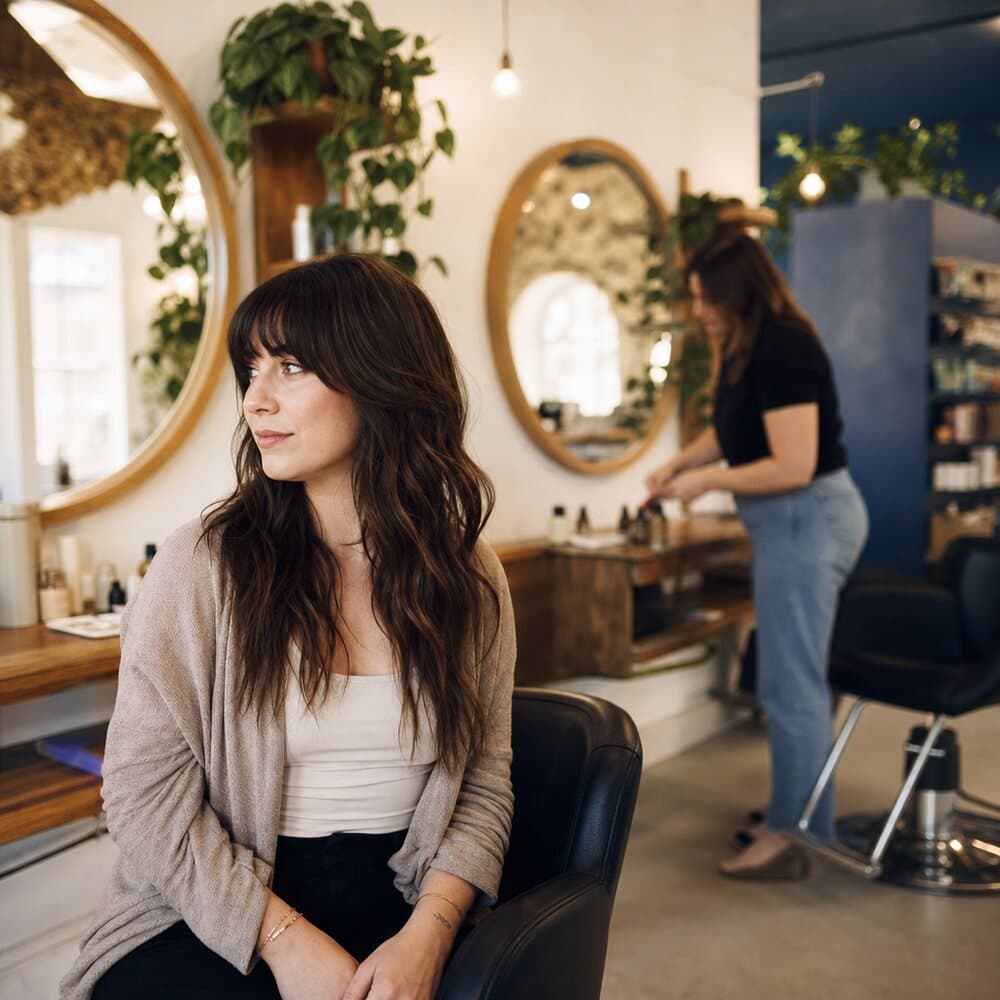 The interior of a warm boutique hair salon.